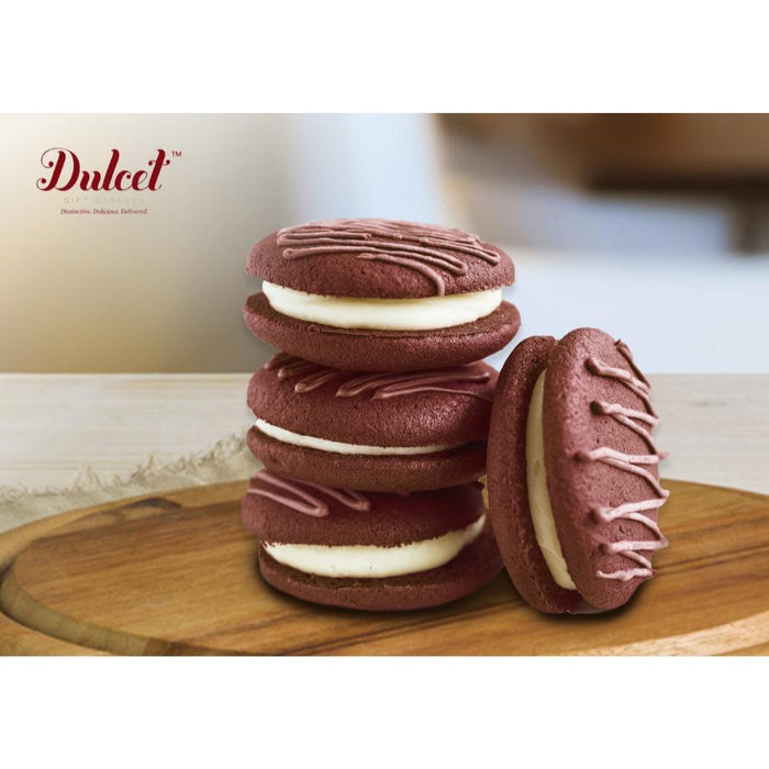 Stack of chocolate sandwich cookies with cream filling, plus a sliced cookie