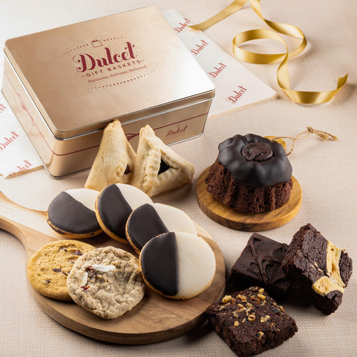 Cookie and brownie gift tin with “Dulcet” lid label and assorted pastries on a wooden board