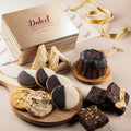 Cookie and brownie gift tin with “Dulcet” lid label and assorted pastries on a wooden board