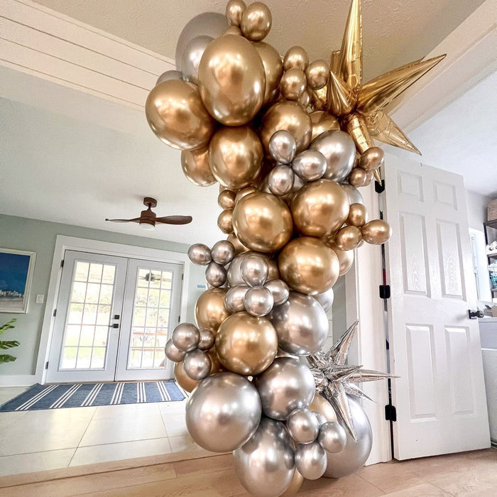 Gold and silver balloon arch with star balloons and dense round clusters