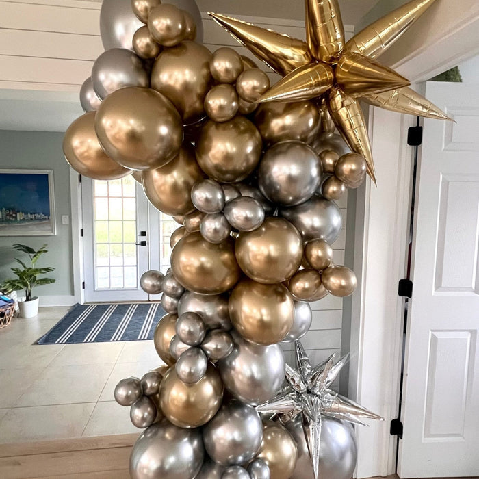 Gold, champagne, and silver balloon arch with metallic star balloons