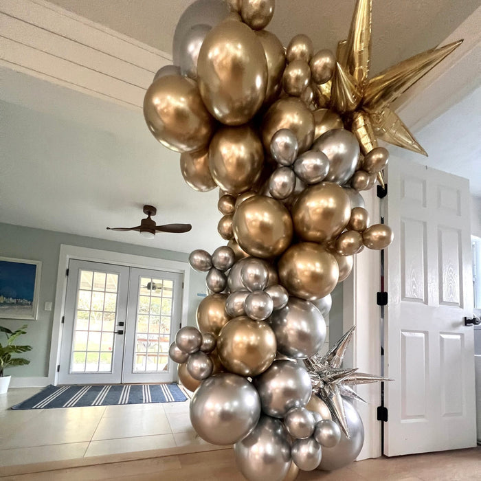Silver and gold balloon arch with star accents, metallic balloon column