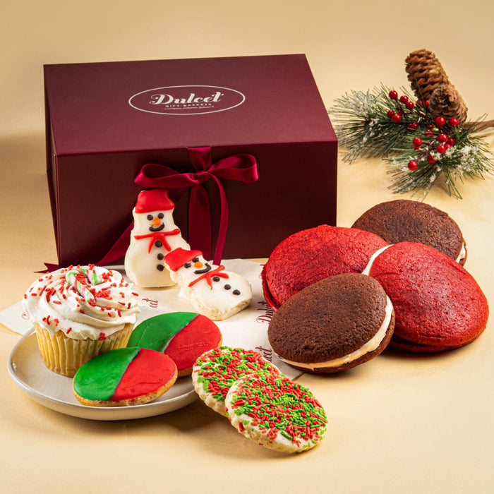 Holiday gift basket with burgundy box, ribbon, and assorted cookies and treats