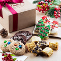 Cardboard gift box with magenta ribbon and assorted holiday cookies on display