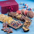 Decorative gift box with ribbon and assorted cookies on a tray