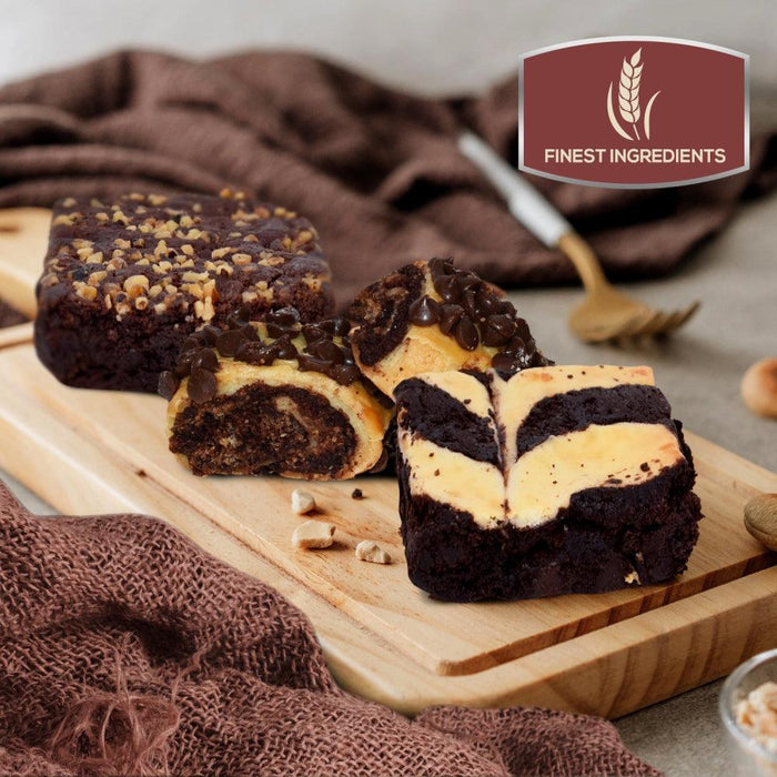 Assorted brownies and cheesecake-style bars on a wooden serving board.