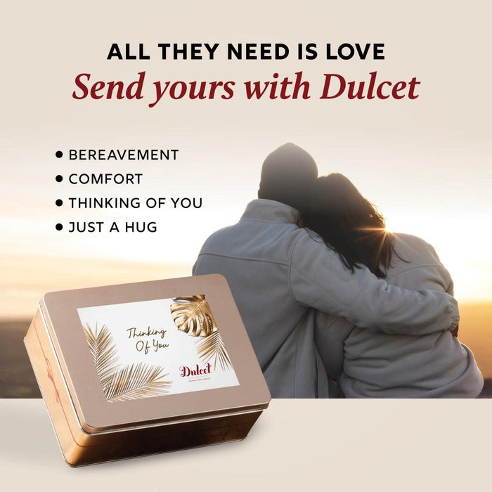 Gift tin with greeting card beside a hugging couple, Dulcet branding