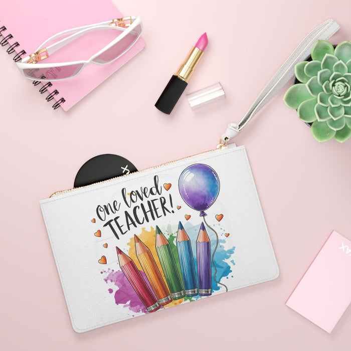 White zip-top clutch bag with 'One loved teacher!' print, colored pencils and balloon