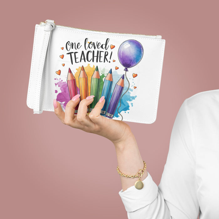White zip-top clutch bag with 'One loved TEACHER!' text, pencils, hearts, and balloon