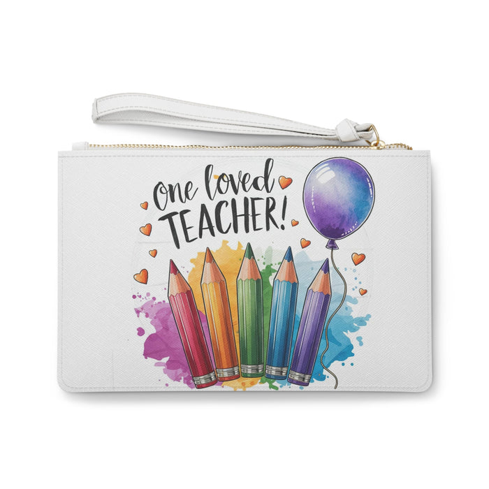 White clutch bag with gold zipper and watercolor pencils, hearts, and balloon graphic