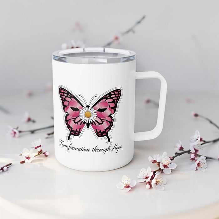 White insulated travel mug with pink butterfly design and “Transformation through Hope” script