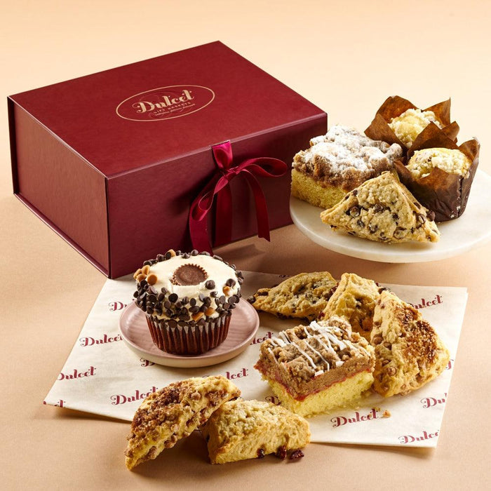 Collection of Sweets Gift gift box with ribbon and assorted cookies on plates