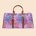 Purple art-print travel duffel bag with brown leather handles and front zipper