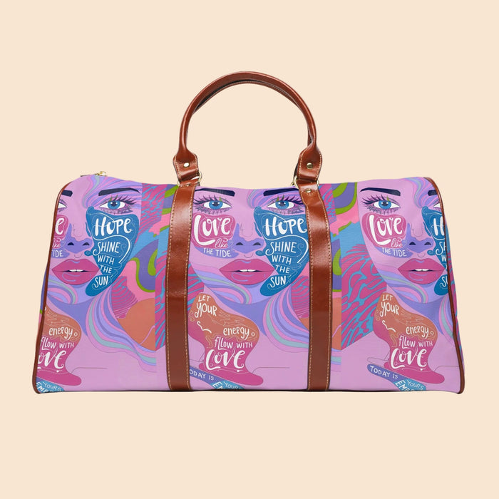 Purple art-print duffel bag with brown leather trim, top handles, and front zipper