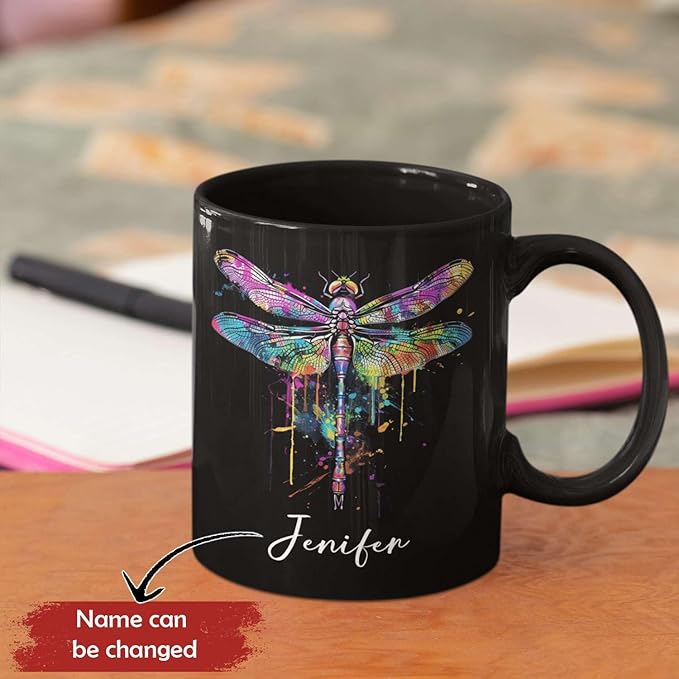 Black ceramic coffee mug with colorful dragonfly print and custom name