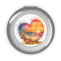 Compact travel mirror with silver glossy round case and heart-shaped beach scene insert