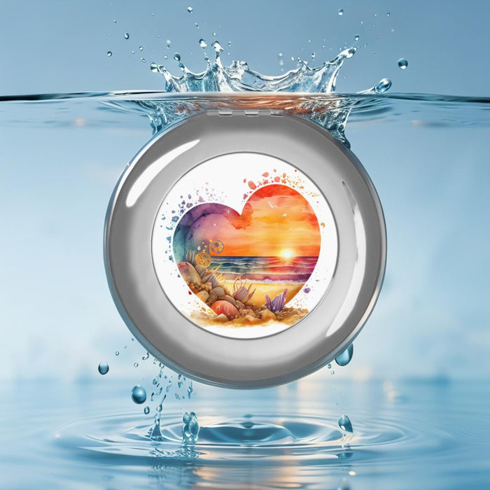 Silver glossy compact travel mirror with heart beach scene design, top view