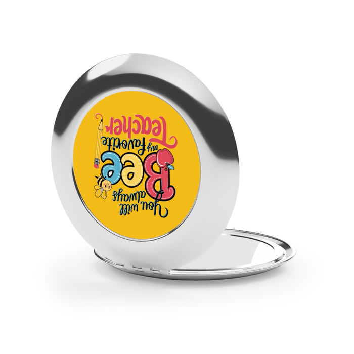 Silver glossy round compact mirror closed, reflective outer lid with Bee design