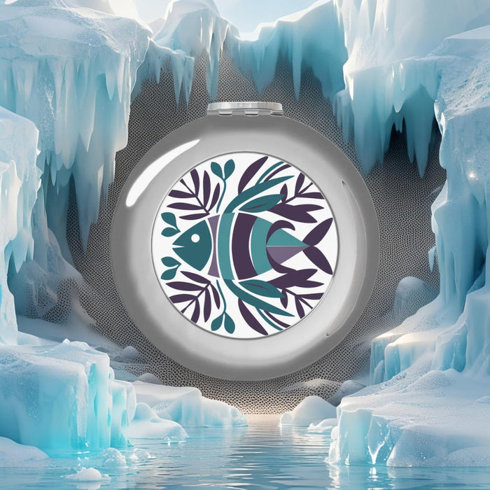 Compact travel mirror with silver glossy frame and fish life graphic in open view