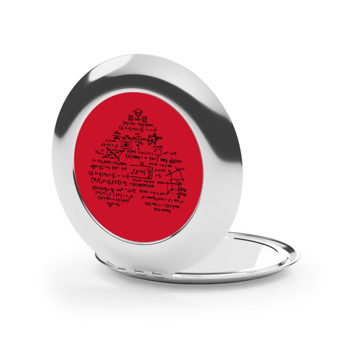Silver glossy compact mirror open flat, showing red math-themed insert