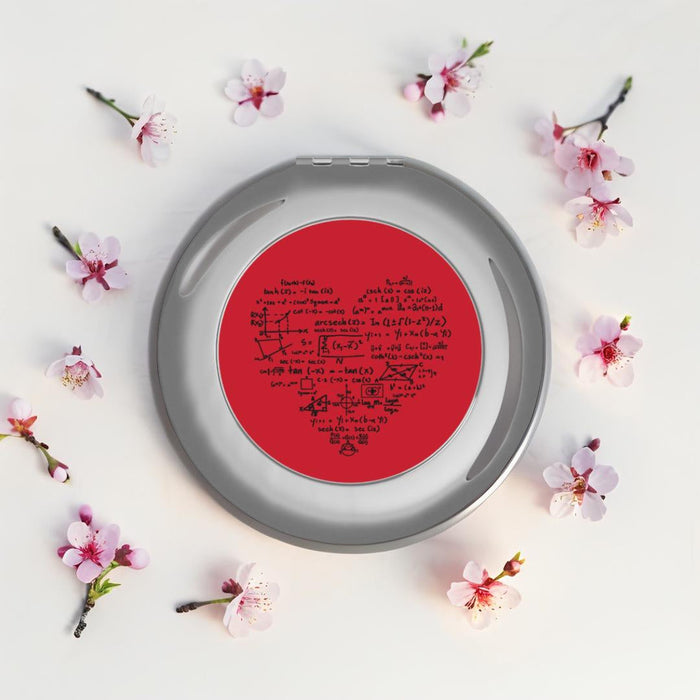 Silver glossy compact travel mirror with red math-themed insert on reflective frame