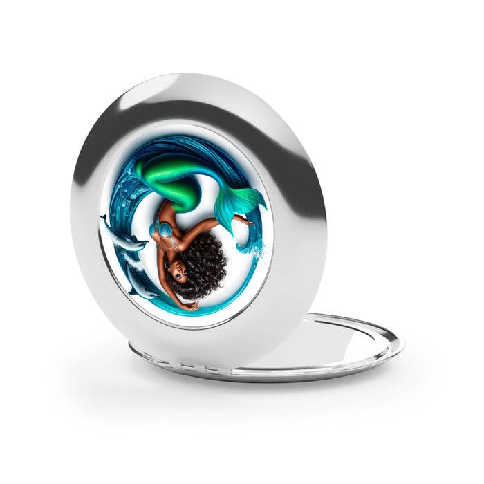 Silver glossy compact travel mirror opened, showing mermaid graphic round panel