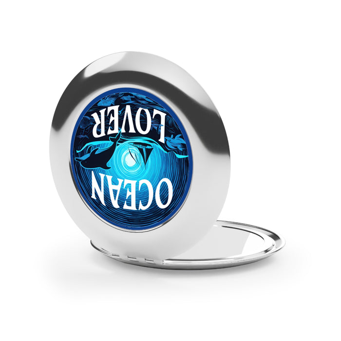 Silver round compact mirror open with Ocean Lover ocean graphic on one side
