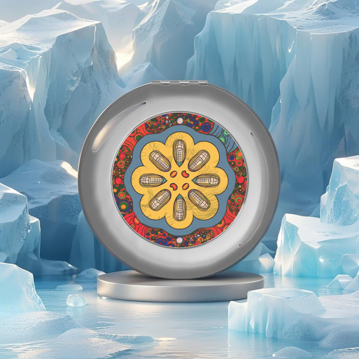 Silver glossy compact mirror standing upright with colorful floral disc artwork