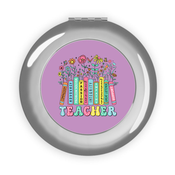 Silver compact travel mirror with purple teacher-themed round design in the center
