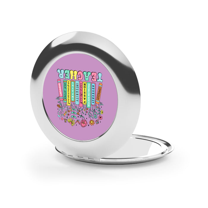 Silver compact travel mirror open, purple teacher-themed artwork on inner panel