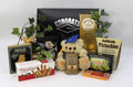 Black "Congrats Grad" gift box with plush bear, nuts, and snack packages.