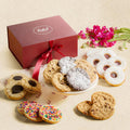 Cookie assortment with sugar-dusted and chocolate-filled cookies beside a maroon gift box