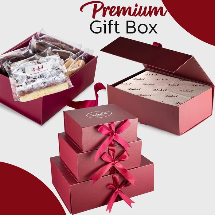 Stack of burgundy gift boxes with pink satin ribbons and tissue-wrapped treats