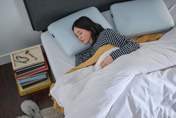 Woman sleeping on a bed. Aerial view.