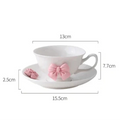 Tea cup and saucer dimensions diagram: white cup with pink bow, 13cm by 15.5cm