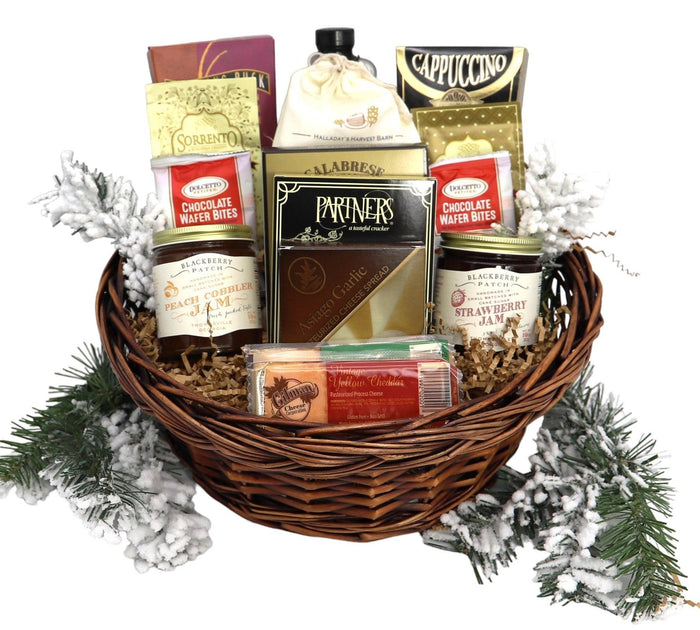 Round wicker breakfast basket with cappuccino packets, pancake mix, jam, and chocolate bites