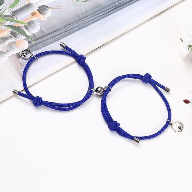 Royal blue braided couple attraction bracelets with charm pendants and metal tube ends