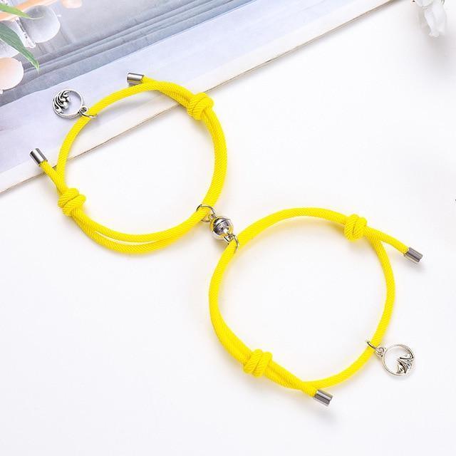 Yellow braided couple attraction bracelets with round charm beads and metal tube ends