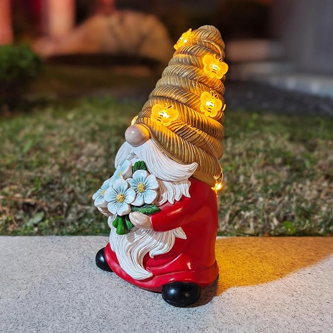 Bee-themed solar LED garden gnome statue, red coat and black boots, blue flower bouquet, lit