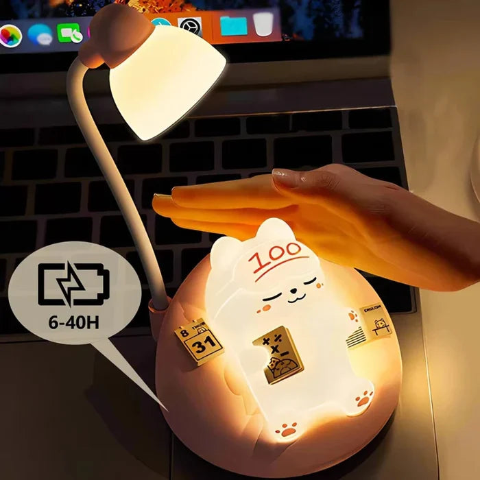 Glowing cat night light on desk, white lamp shade and round pink base