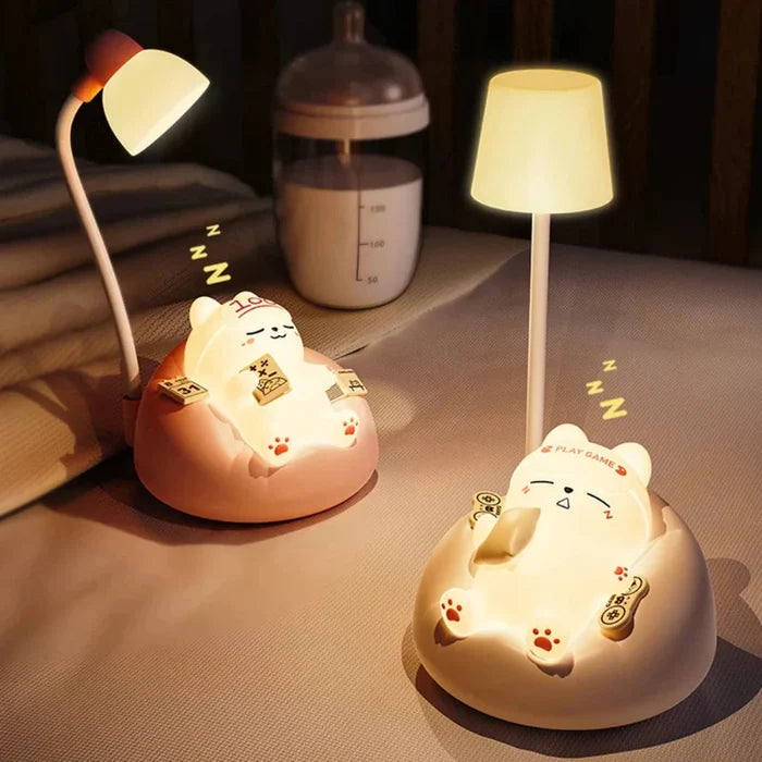Two glowing cat night lights on bed, round bases with warm light
