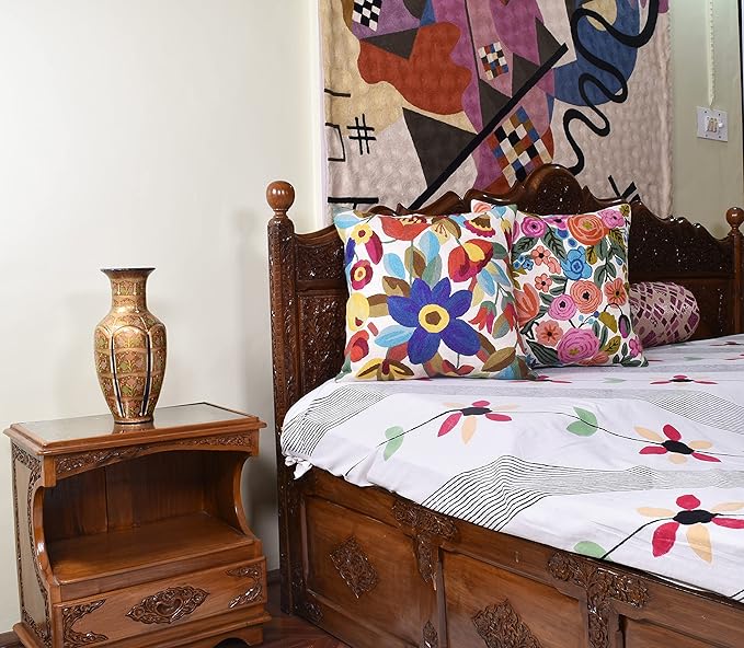 Floral accent pillows on bed, multicolor flower design on white pillow covers