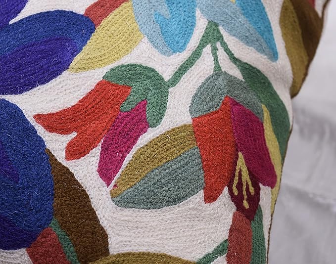 Close-up of multicolor leaf and flower embroidery on white pillow cover