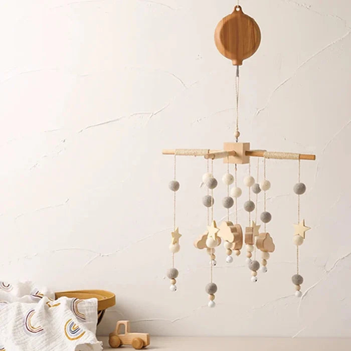 Crib hanging music mobile with wooden whale and star-and-ball bell charms