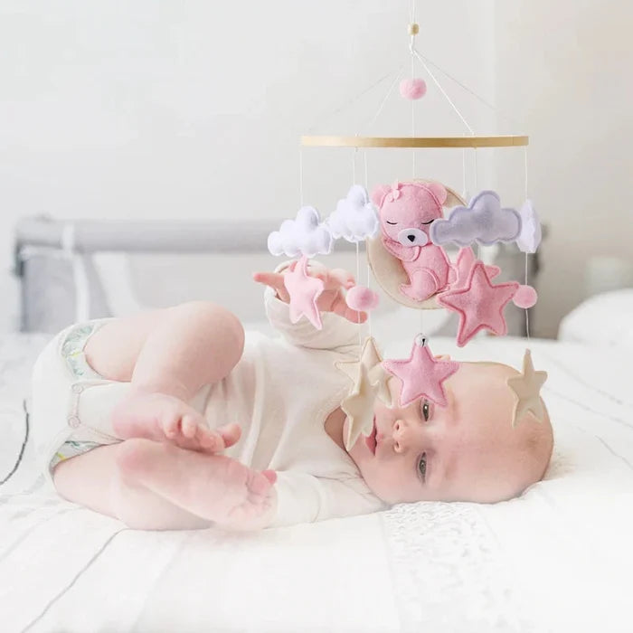 Crib mobile rattle with felt bear, clouds, and star shapes hanging from a wooden ring