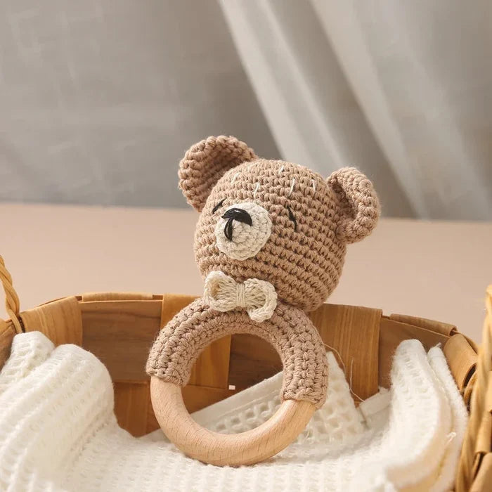 Crochet teddy bear teether with wooden ring and stitched face, beige with dark details