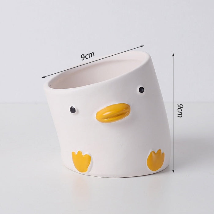 White duck ceramic planter with yellow beak and orange feet; 9cm wide, 6cm high.