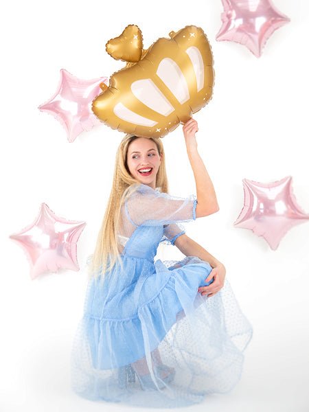 Gold crown balloon with heart topper, held above a blue tulle dress