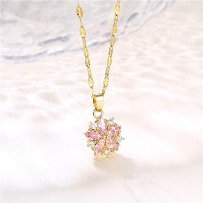 Gold-tone chain necklace with pink cherry blossom pendant, small crystal sparkle