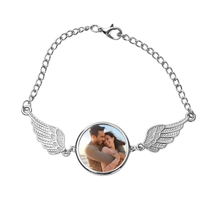Silver angel wings photo bracelet with round photo center and wing charms